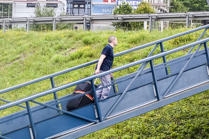 Sailor with suitcase on EMERALD STAR gangway, Trier