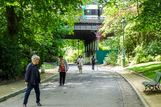 RER train speeding through Parc Montsouris