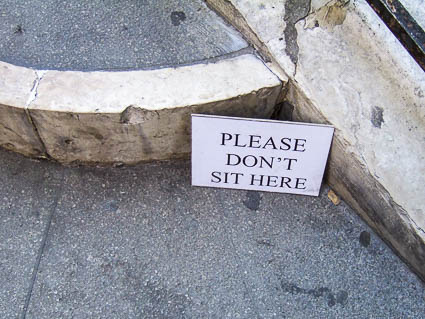 Venice "Please don't sit here" sign on bridge