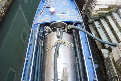 Pozzo Nero boat sucking up septic-tank sludge in Venice, Italy