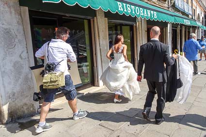 Wedding photographer with bridal couple