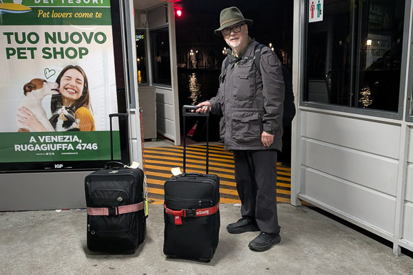 Durant Imboden waits for ACTV N night boat at Ca' d'oro vaporetto stop in Venice, Italy.