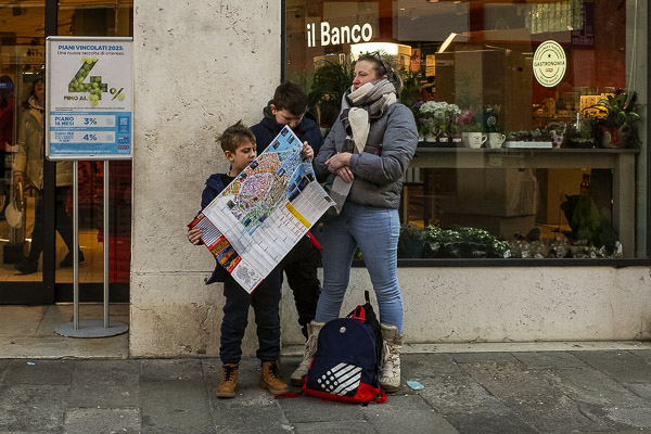 Visitors with pper map in Venice, Italy.