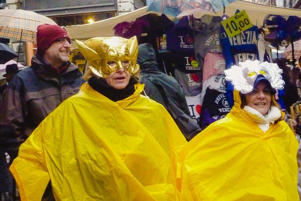 Carnival performers in rain ponchos, Venice, Italy.